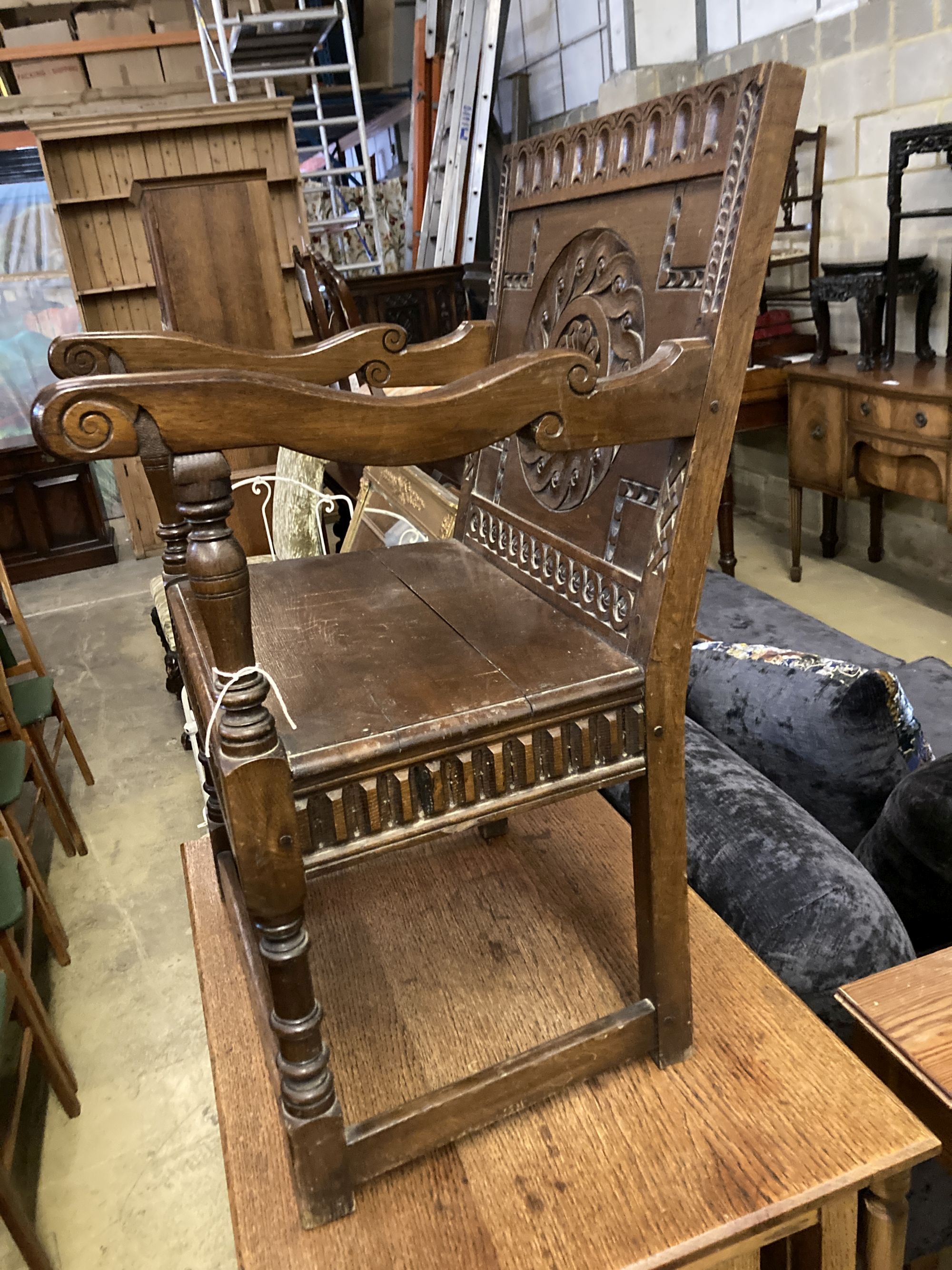 An 18th century style oak wainscot type elbow chair, width 58cm, depth 45cm, height 89cm